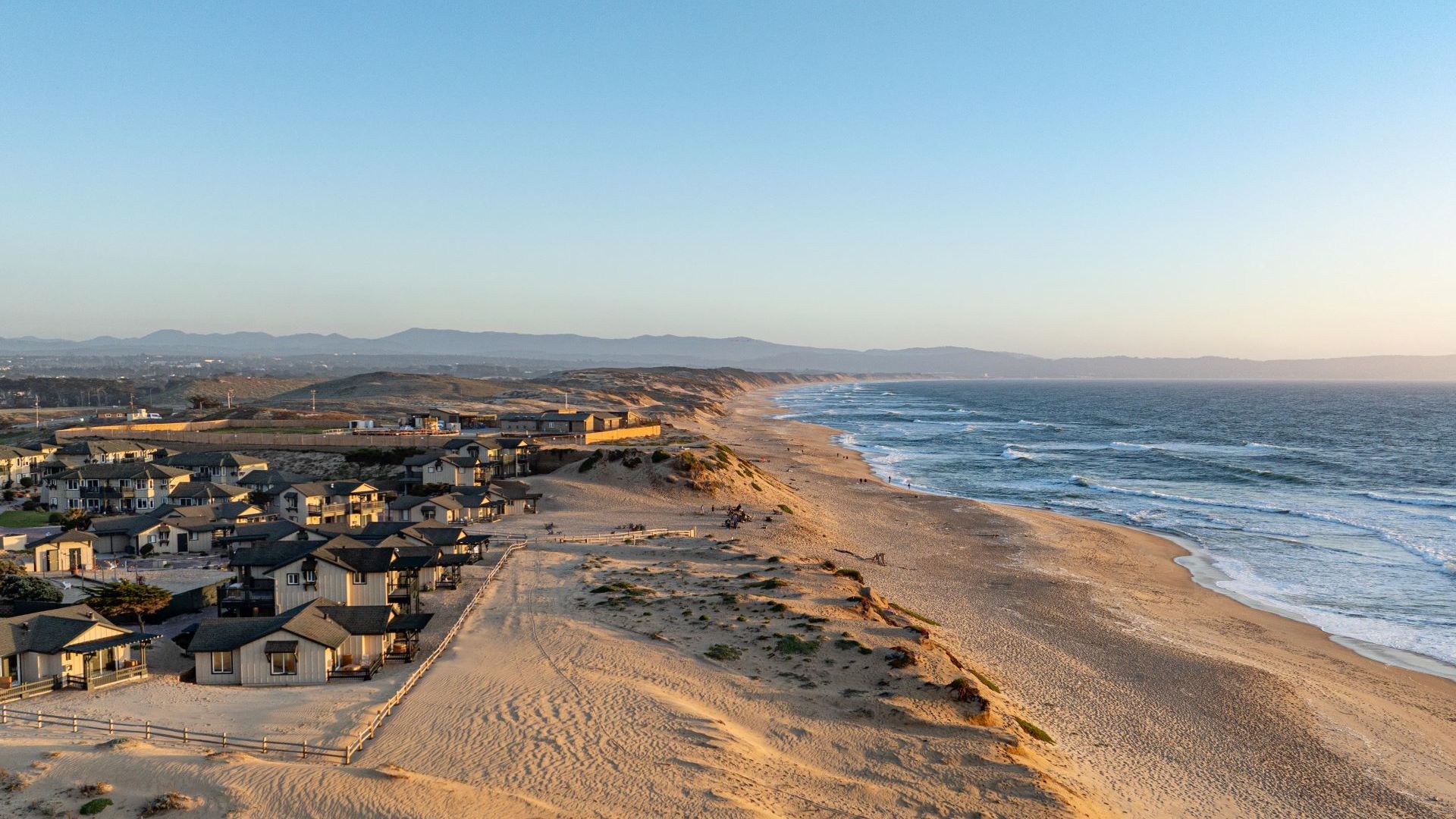 A Beach With Houses Along It