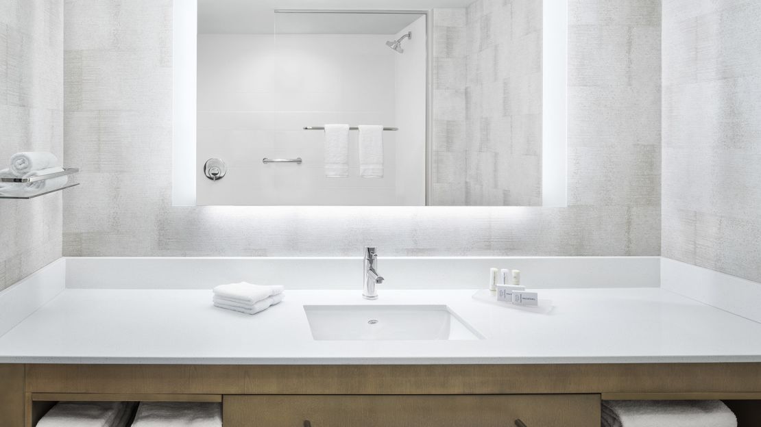 A Bathroom With A Large Mirror