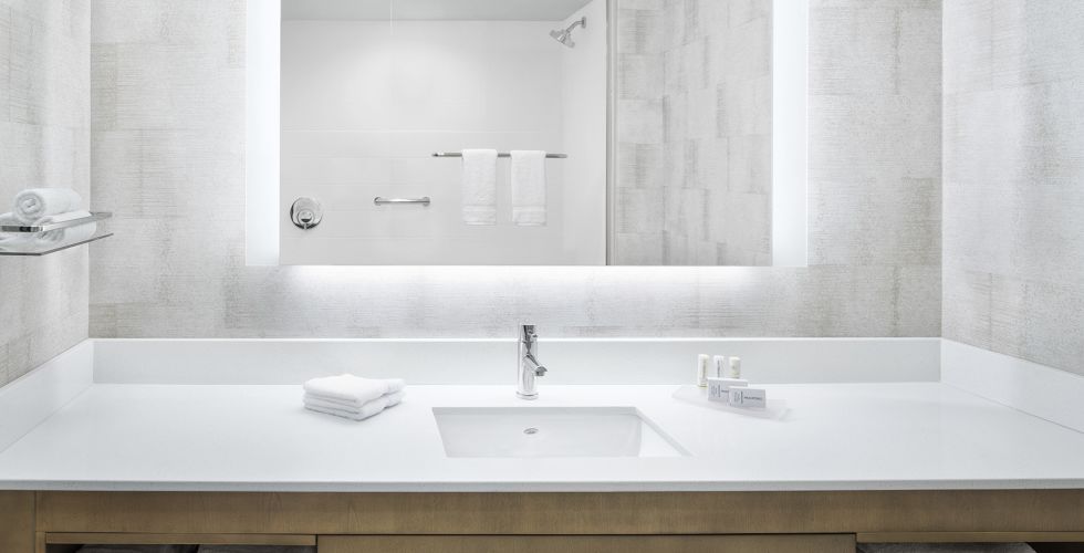A Bathroom With A Large Mirror