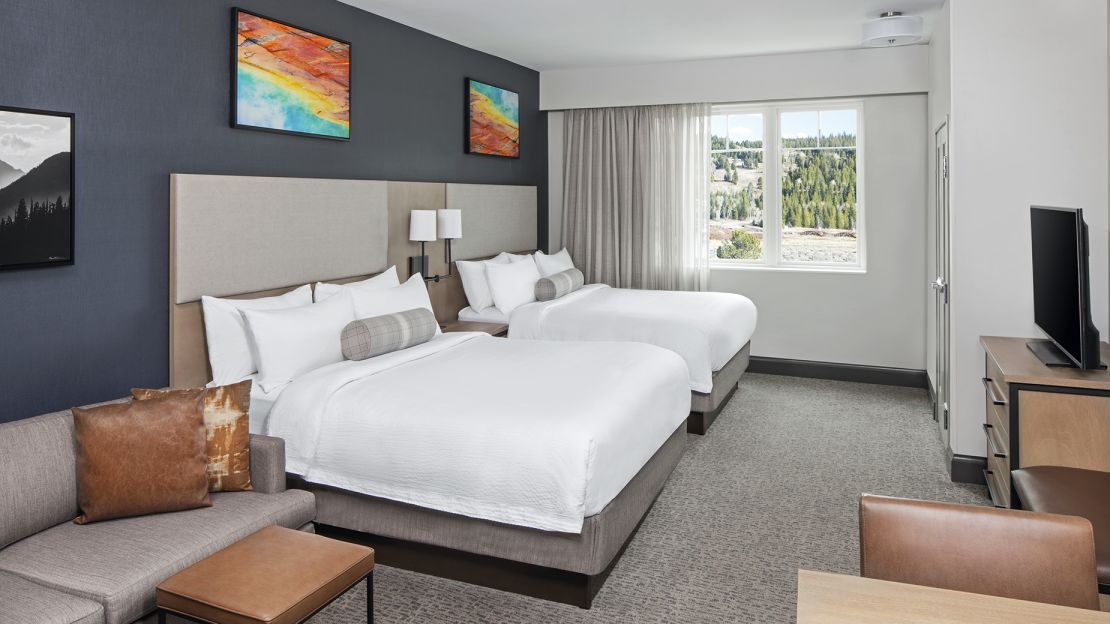 A Bedroom With A Bed And Couches
